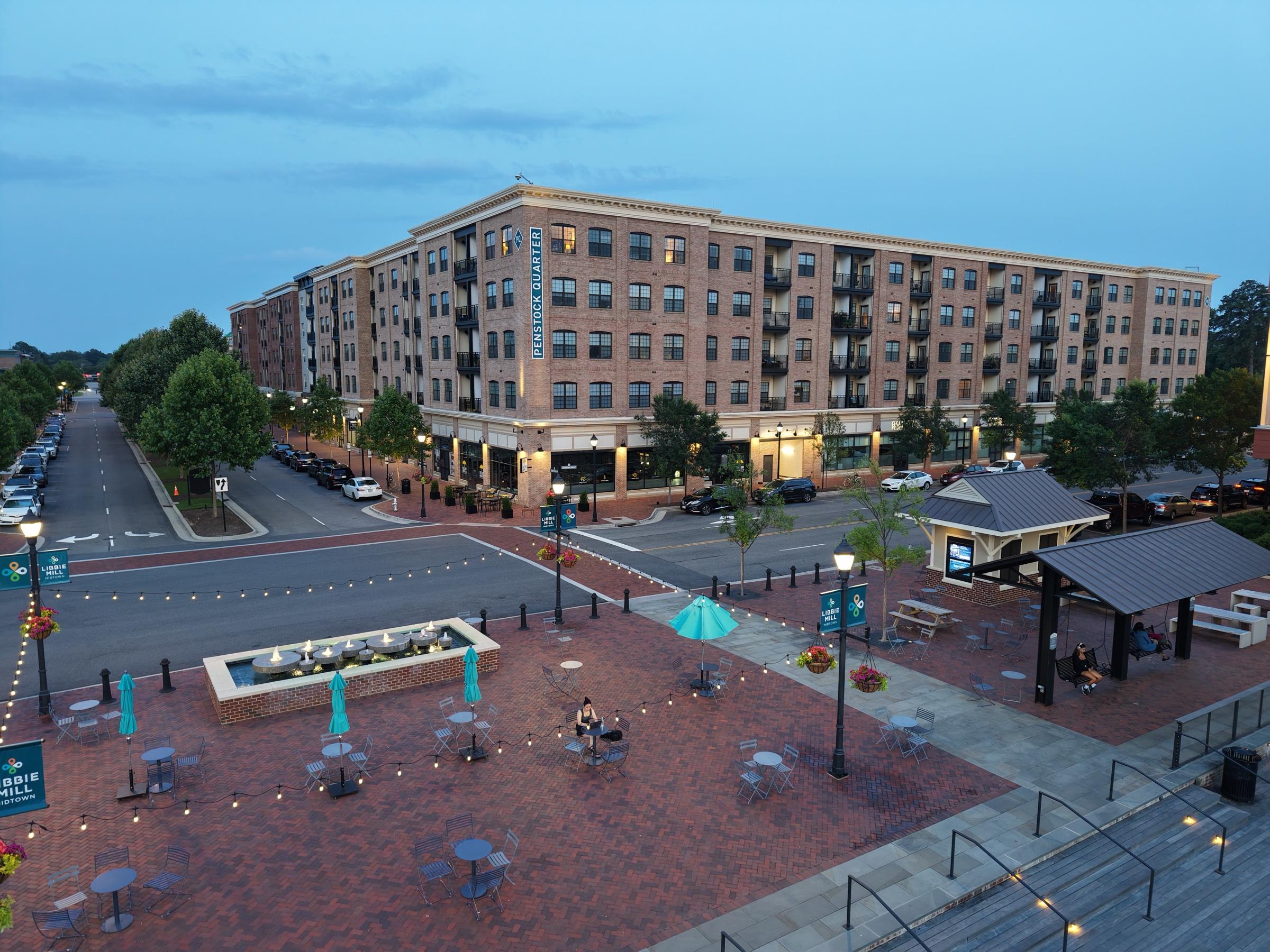 Mixed-use buildings and the plaza at Libbie Mill at dusk