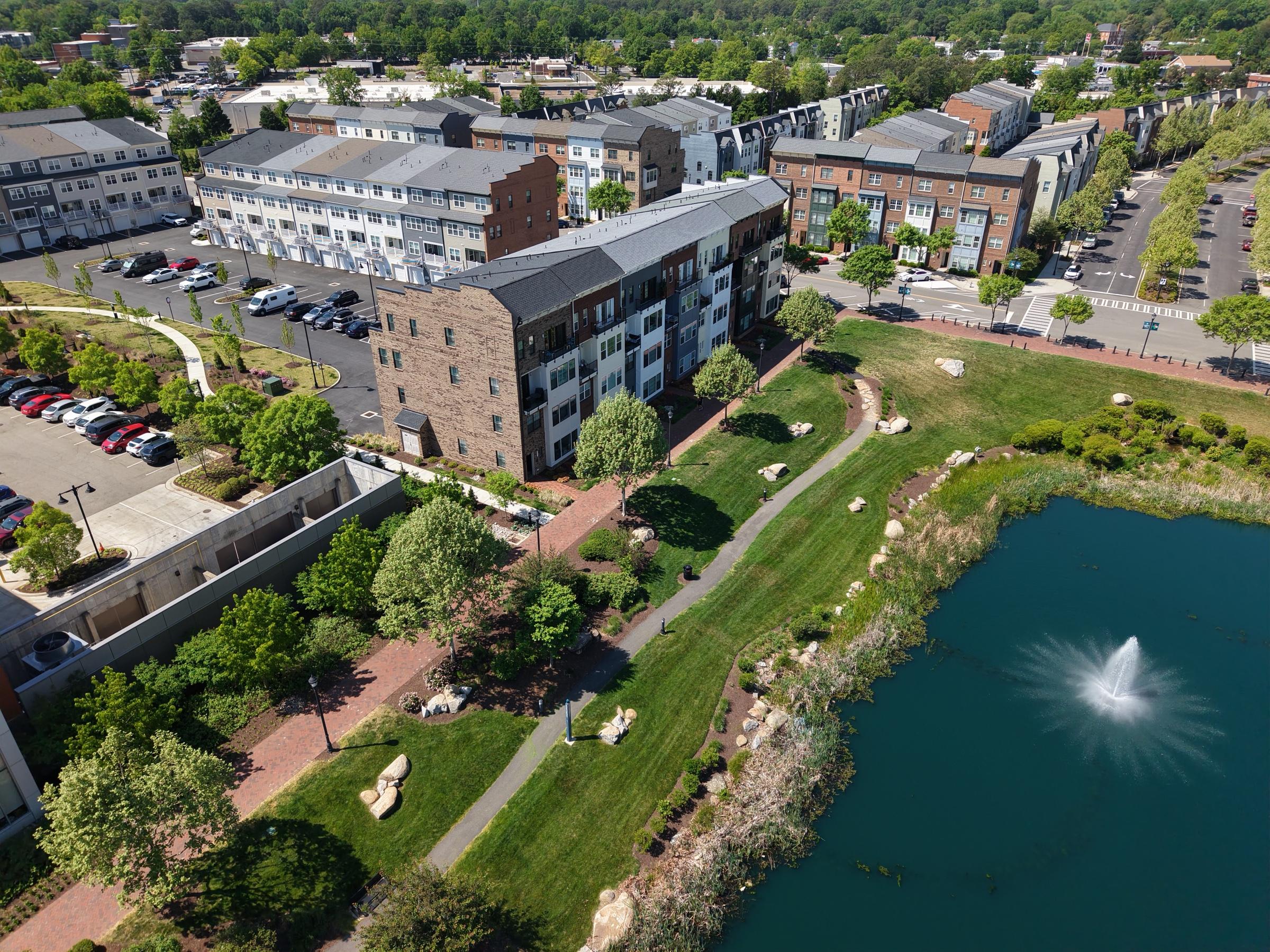 Aerial view of the pond, fountain and green beside the buildings at Libbie Mill