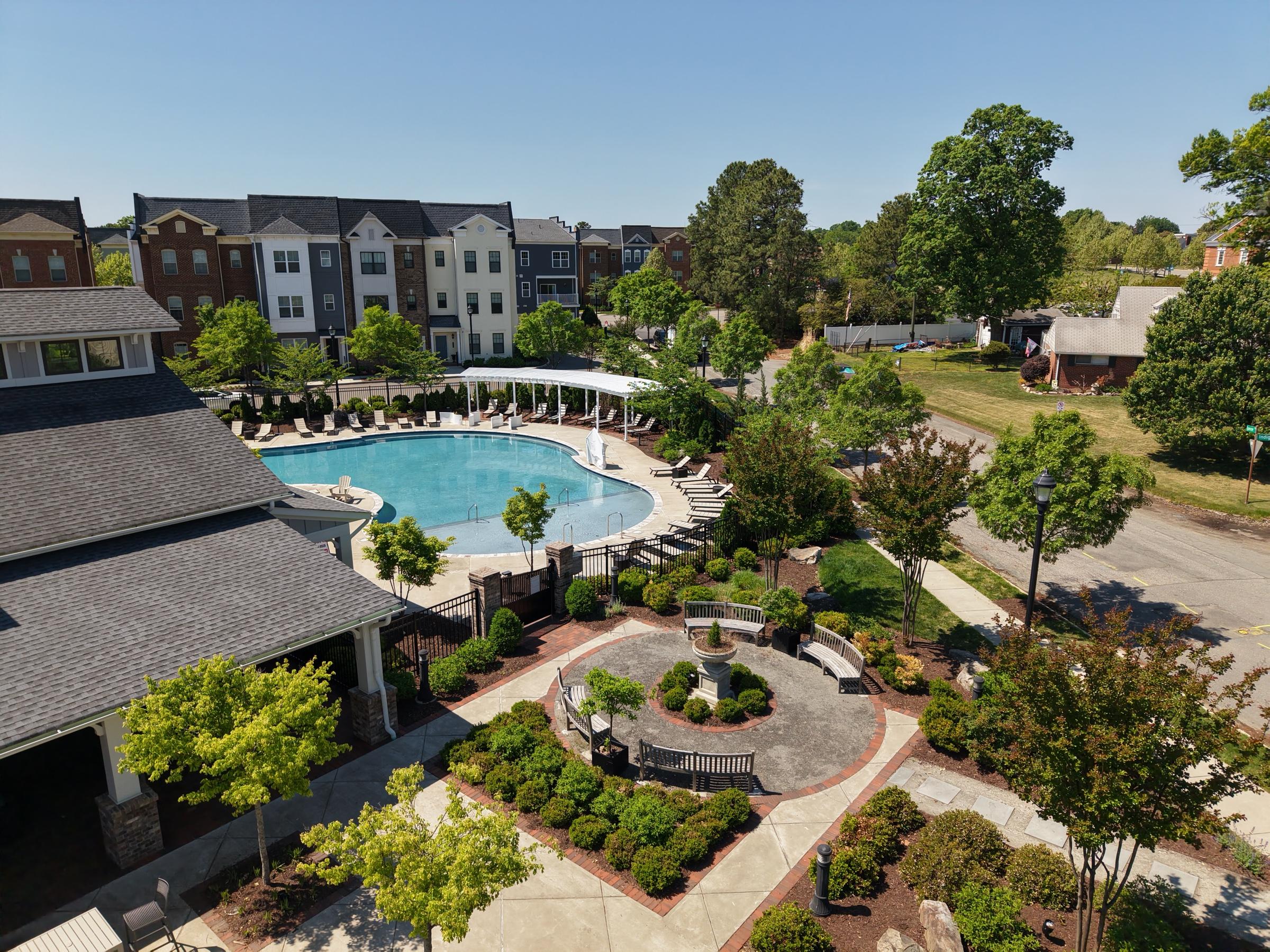 Aerial view of an apartment courtyard with a pool and landscaped paths