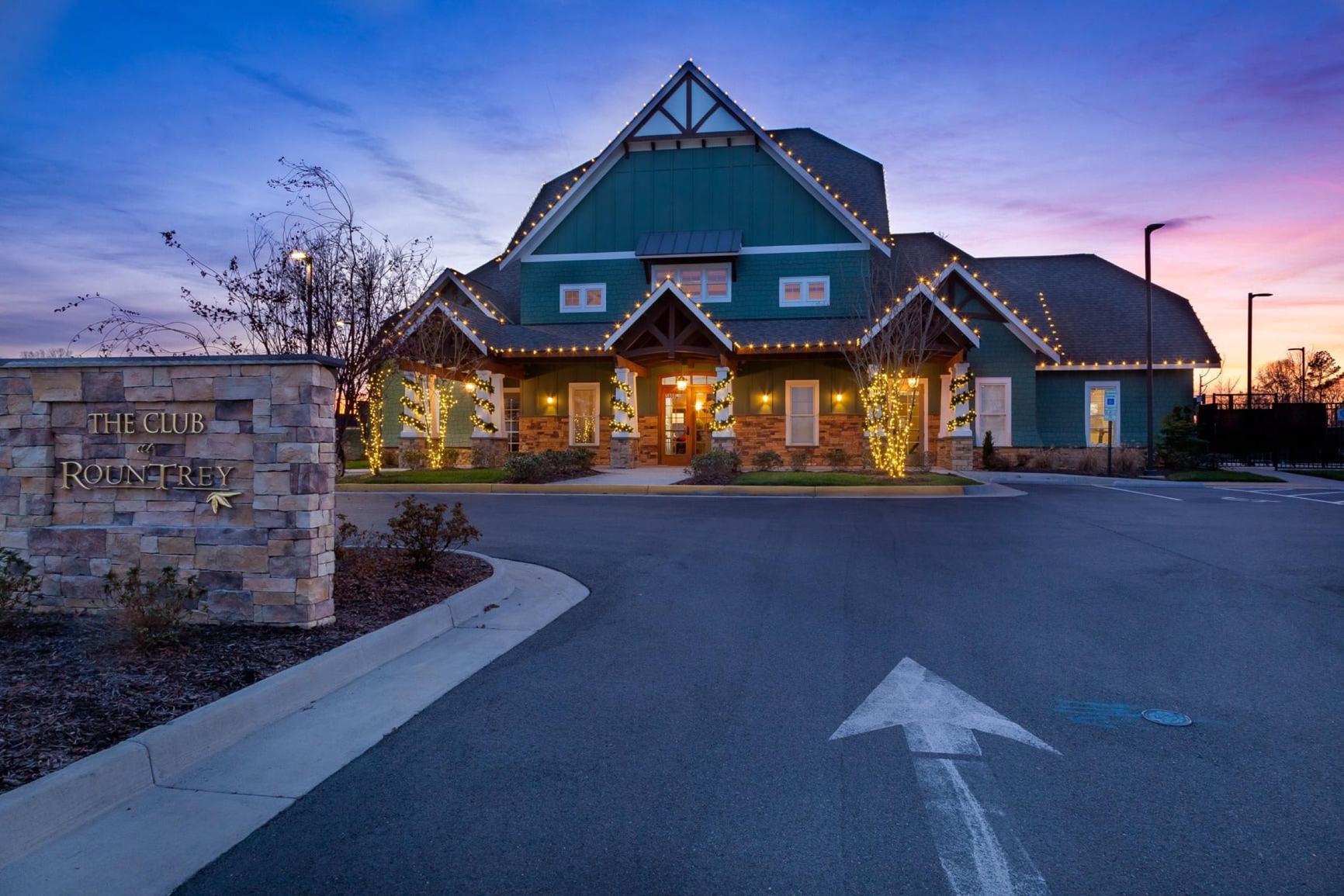 The Rountrey clubhouse lit up at dusk